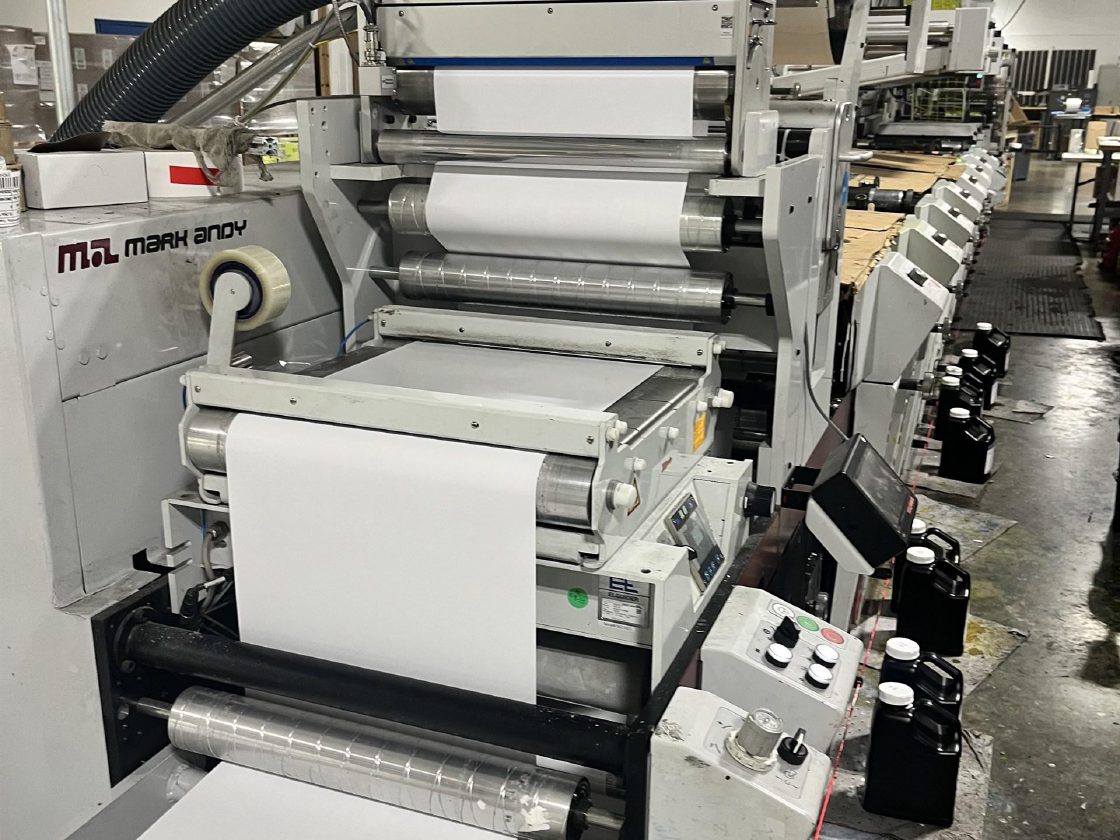 Unprinted web threaded up through a Vetaphone corona treater and down into the first print deck of the press